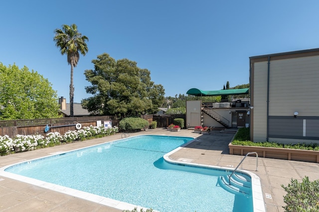 pool featuring a patio and a fenced backyard