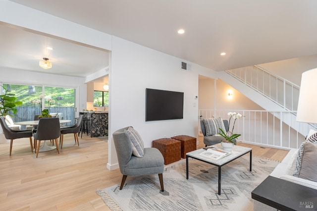 living area with light wood finished floors, stairs, visible vents, and recessed lighting