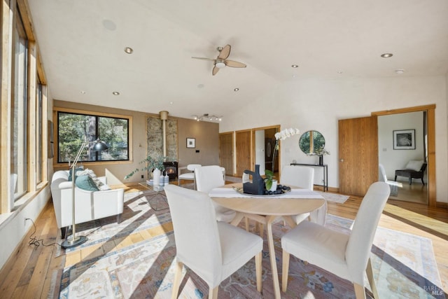 224 Arroyo Rd, Forest Knolls, CA 94933 - dining space with recessed lighting, light wood-style flooring, a ceiling fan, a wood stove, and vaulted ceiling