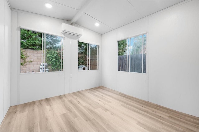 unfurnished room featuring recessed lighting, wood finished floors, and a wall mounted air conditioner