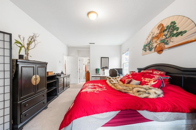 bedroom with visible vents and light colored carpet