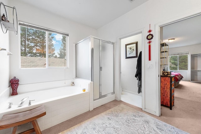 bathroom featuring ensuite bath, a stall shower, and a garden tub