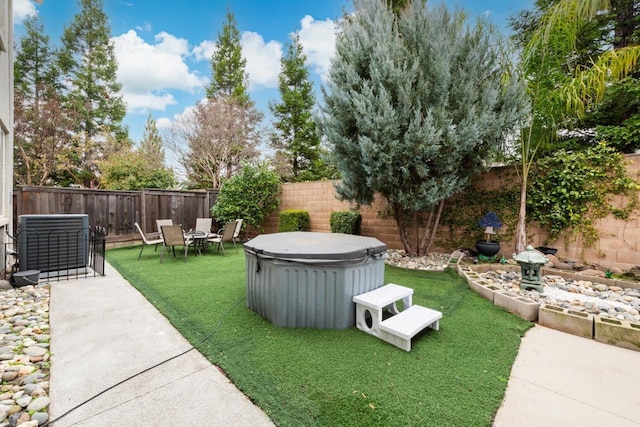 view of yard featuring a patio area, a fenced backyard, and central AC