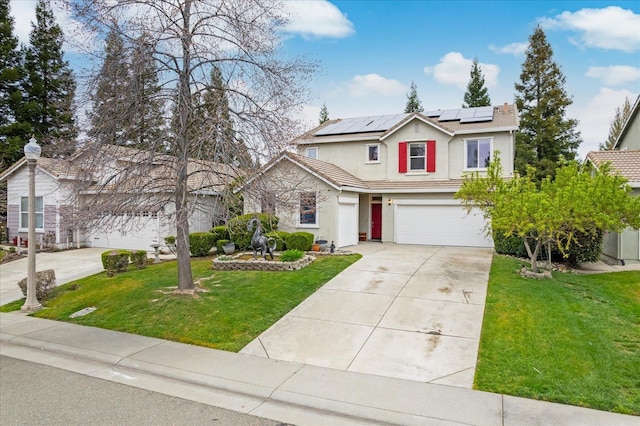 traditional-style home with driveway, an attached garage, roof mounted solar panels, a front lawn, and stucco siding