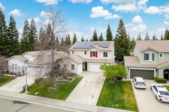 traditional home featuring driveway, a garage, a front yard, and a tiled roof