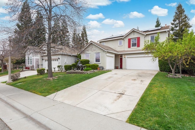 traditional home featuring driveway, an attached garage, roof mounted solar panels, a front lawn, and stucco siding