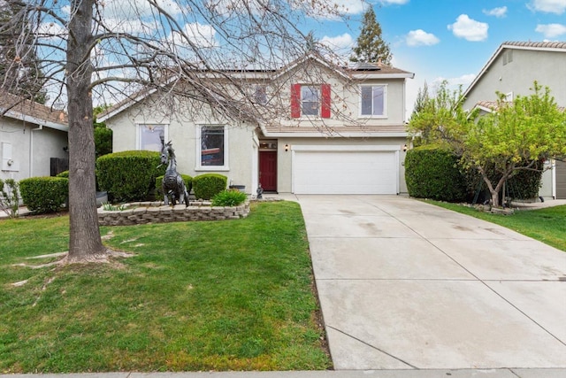 view of front of home featuring a garage, driveway, stucco siding, roof mounted solar panels, and a front yard