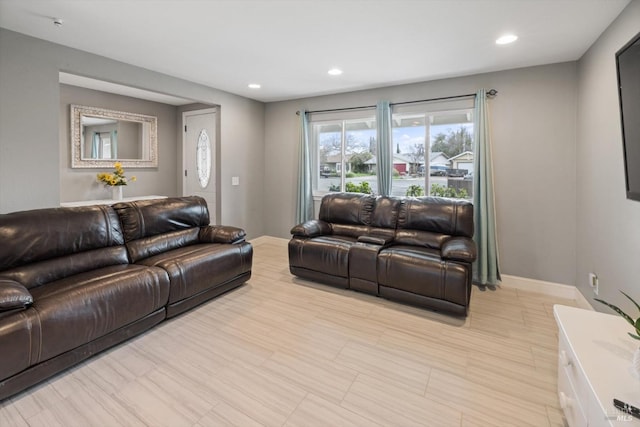 living area with baseboards and recessed lighting