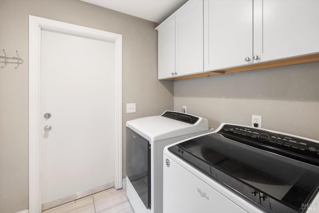 laundry room featuring cabinet space and washing machine and dryer