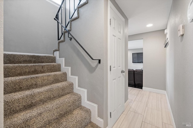 stairway featuring recessed lighting and baseboards