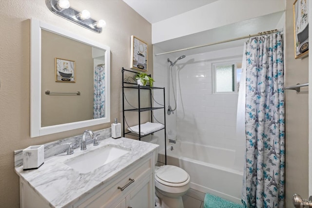 bathroom featuring toilet, a textured wall, shower / bath combination with curtain, and vanity