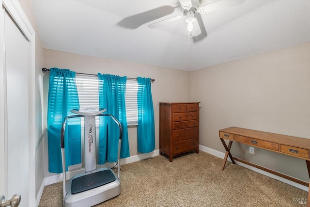 workout area with carpet floors, ceiling fan, and baseboards