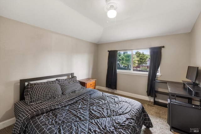 bedroom with a ceiling fan, carpet flooring, vaulted ceiling, and baseboards