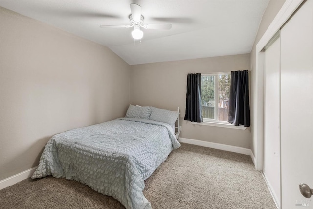 bedroom featuring vaulted ceiling, a closet, carpet, and baseboards