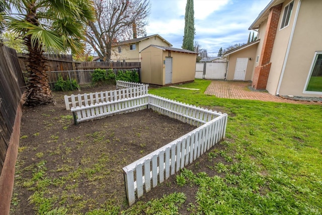 view of yard featuring a patio area, a fenced backyard, a storage unit, and an outdoor structure