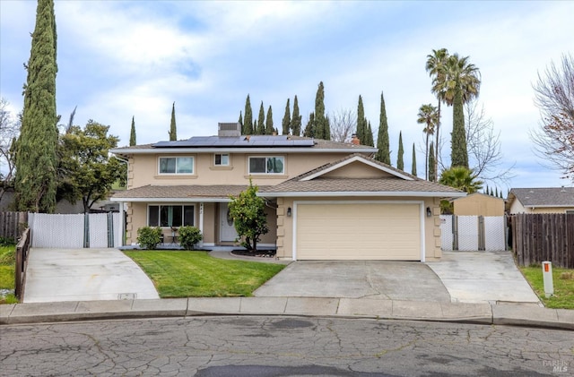 traditional-style house featuring driveway, a gate, fence, and stucco siding