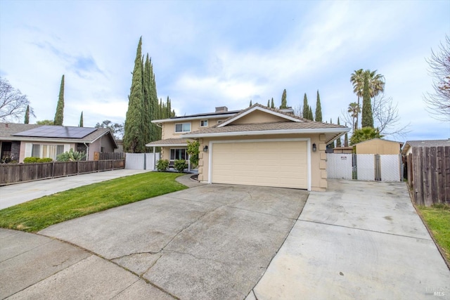 view of front facade with a garage, fence, driveway, stucco siding, and a front yard