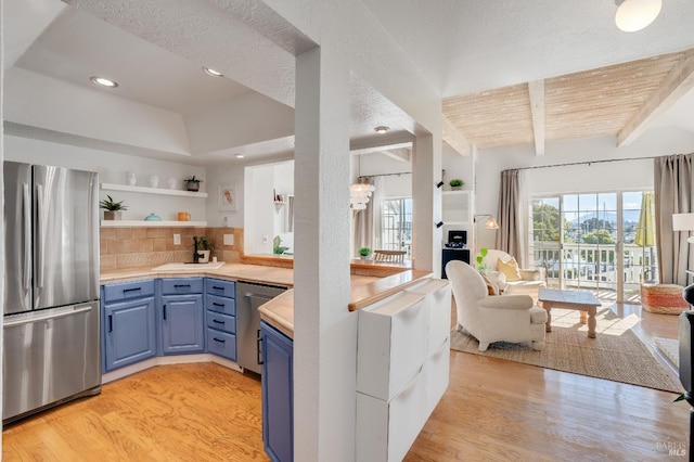 kitchen featuring light wood-style floors, stainless steel appliances, blue cabinetry, open shelves, and beam ceiling