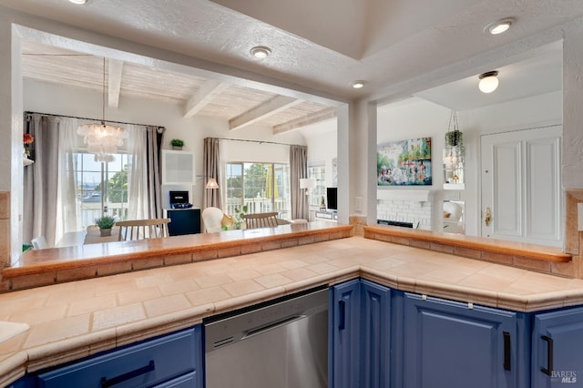 kitchen with beam ceiling, a healthy amount of sunlight, dishwasher, and blue cabinetry