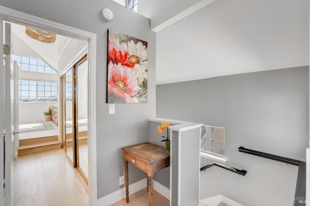 interior space with vaulted ceiling and baseboards