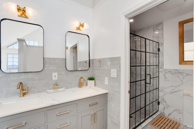 full bathroom with tile walls, a sink, and a shower stall