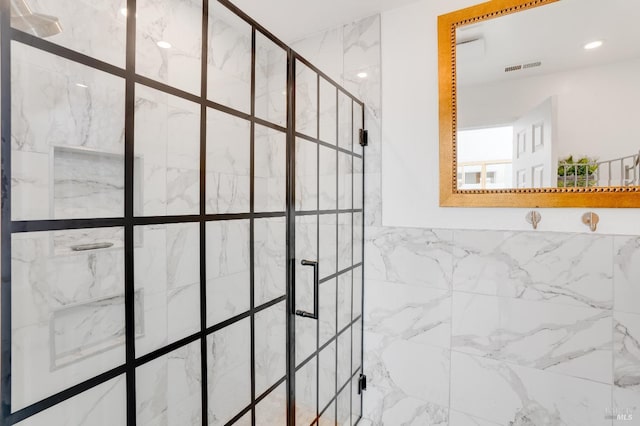 full bathroom with recessed lighting, visible vents, and a shower stall