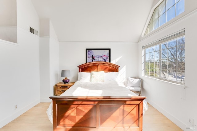 bedroom featuring visible vents, light wood-style flooring, and baseboards