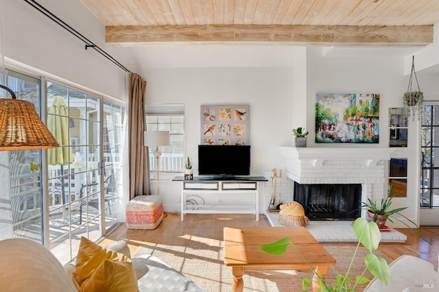 living room with wood ceiling, a fireplace, beamed ceiling, and wood finished floors