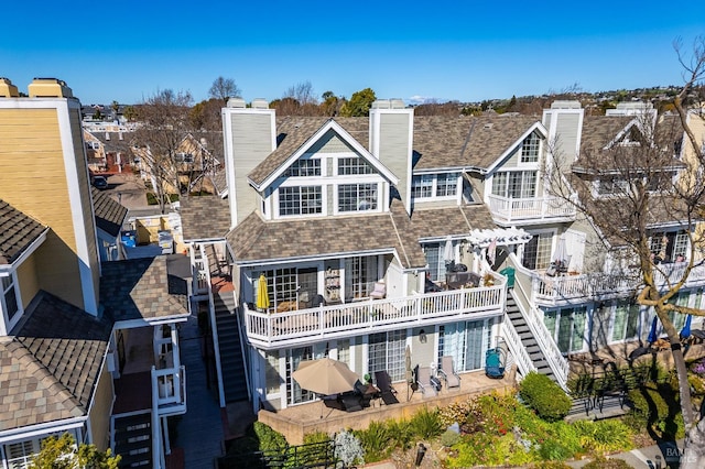 rear view of property with a chimney and a residential view