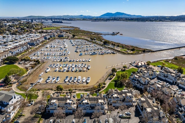 birds eye view of property with a water and mountain view