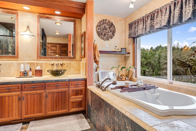 full bathroom with a bath, tasteful backsplash, and vanity