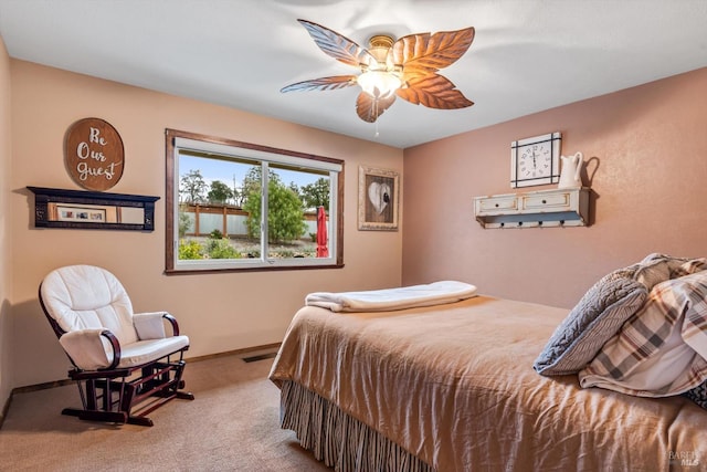 carpeted bedroom featuring ceiling fan, visible vents, and baseboards