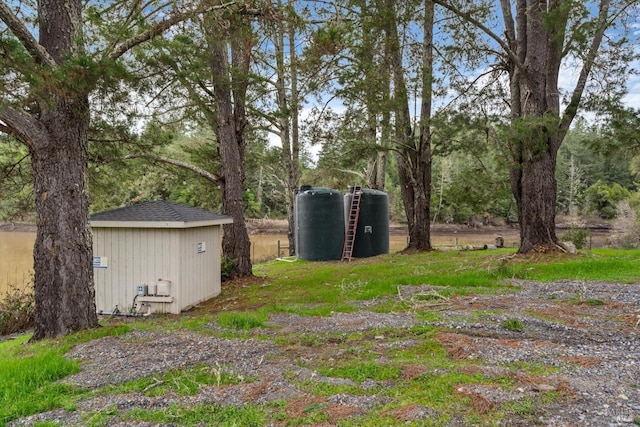 view of yard featuring a shed and an outbuilding