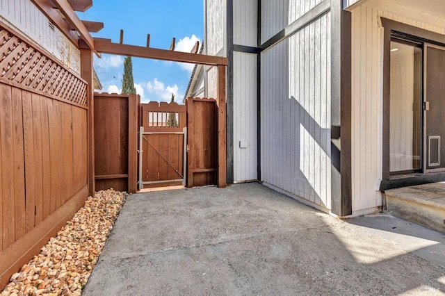 view of patio with fence and a gate