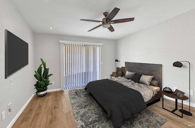 bedroom featuring baseboards, light wood-style flooring, a ceiling fan, and access to exterior