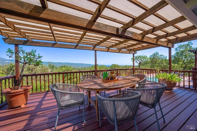 deck featuring a pergola and outdoor dining space