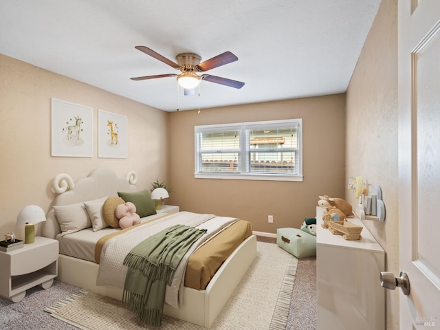 carpeted bedroom featuring ceiling fan and baseboards