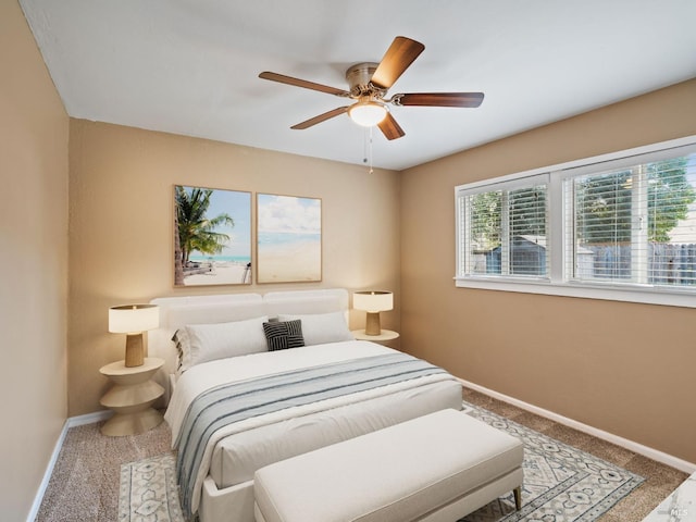 carpeted bedroom featuring ceiling fan and baseboards