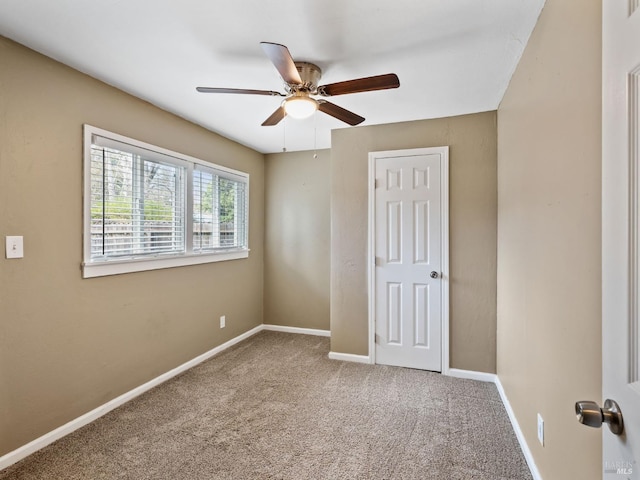 unfurnished bedroom featuring carpet, baseboards, and ceiling fan