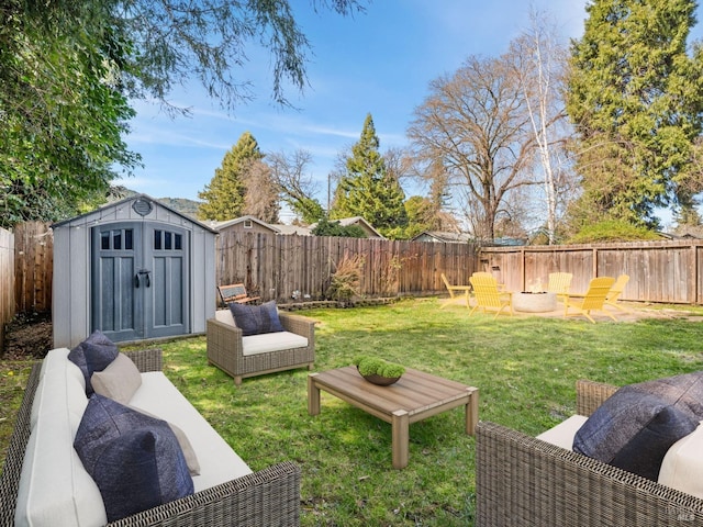 view of yard with a fenced backyard, an outdoor structure, an outdoor hangout area, and a storage unit