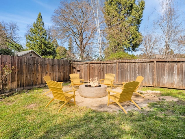 view of yard with a fire pit and fence