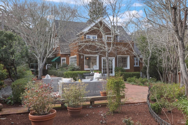 view of front of house featuring roof with shingles and french doors