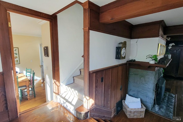 bar with crown molding, stairway, and wood finished floors