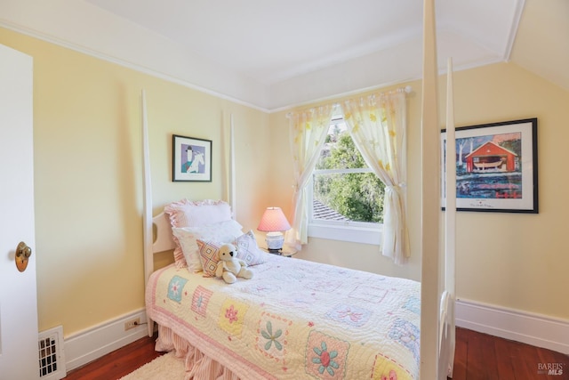 bedroom featuring baseboards, vaulted ceiling, and wood finished floors