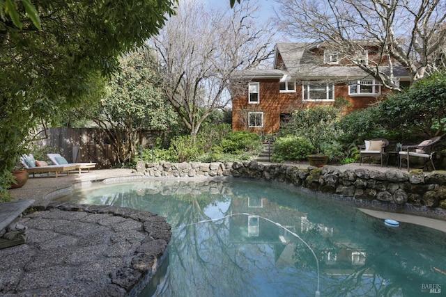 view of pool with a patio, fence, and a fenced in pool