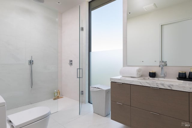 bathroom featuring a stall shower, vanity, and toilet