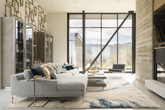 tiled living room featuring floor to ceiling windows