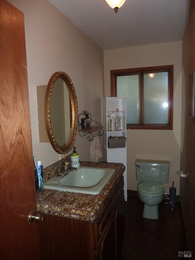 bathroom featuring toilet, tile patterned floors, and vanity