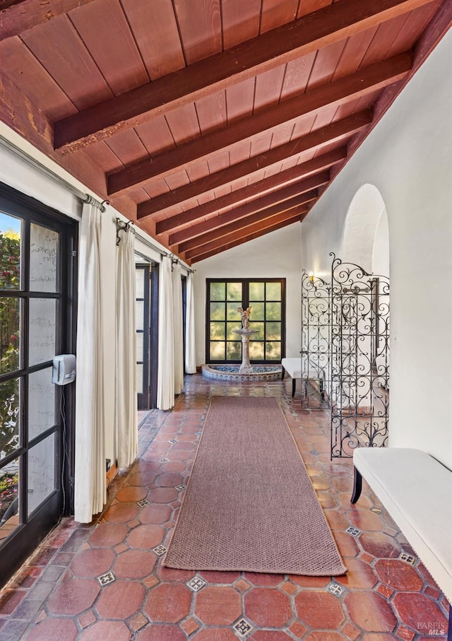 interior space with vaulted ceiling with beams, wood ceiling, and french doors