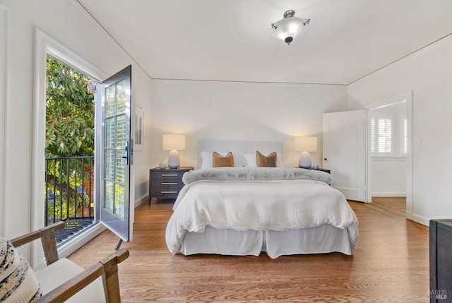 bedroom featuring wood finished floors and baseboards